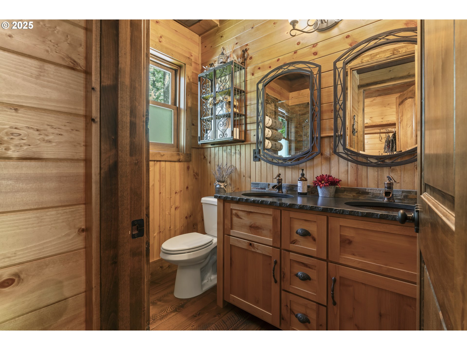 55590 McKenzie River Drive Blue River, OR 97413 - Photo 10 of 45 a bathroom with a toilet a sink and a mirror