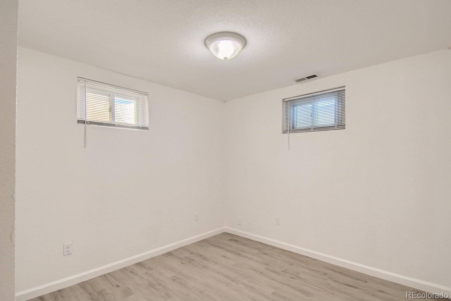 7480 Wolff Street Westminster, CO 80030 - Photo 13 of 16 a view of an empty room with wooden floor