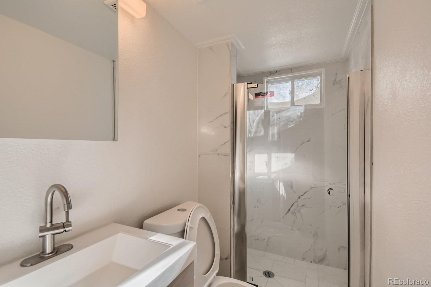 7480 Wolff Street Westminster, CO 80030 - Photo 14 of 16 a bathroom with a sink and mirror