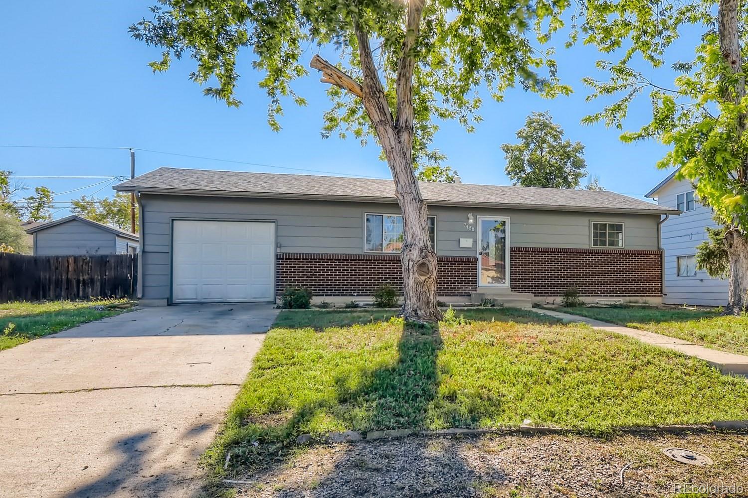 7480 Wolff Street Westminster, CO 80030 - Photo 2 of 16 front view of a house with a yard