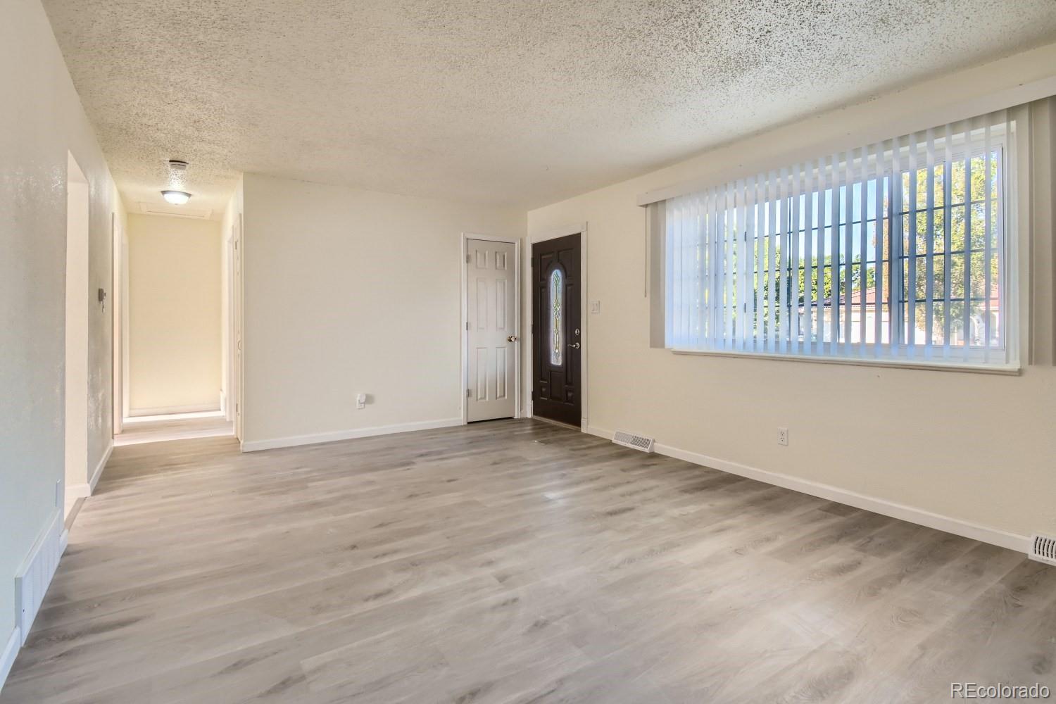 7480 Wolff Street Westminster, CO 80030 - Photo 4 of 16 a view of an empty room with a window