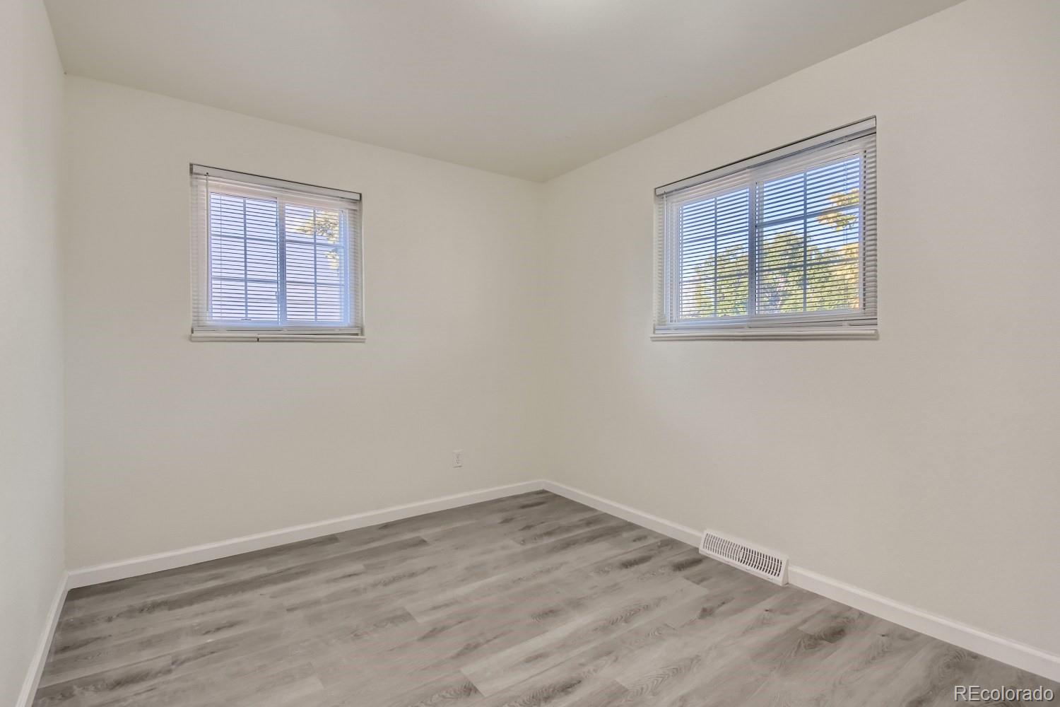 7480 Wolff Street Westminster, CO 80030 - Photo 8 of 16 a view of an empty room with wooden floor and a window