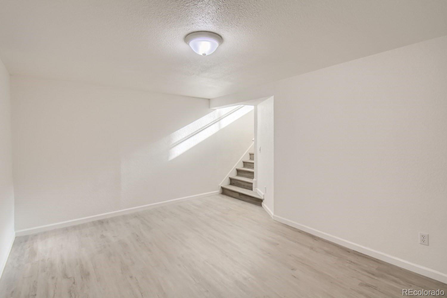 7480 Wolff Street Westminster, CO 80030 - Photo 9 of 16 a view of an empty room with stairs