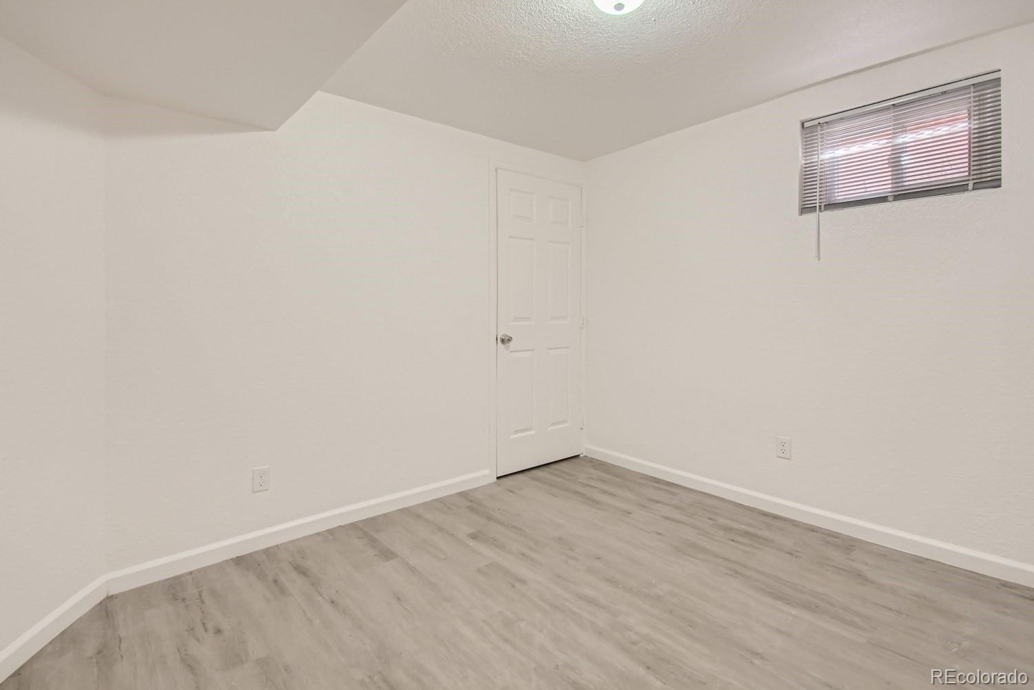 7480 Wolff Street Westminster, CO 80030 - Photo 10 of 16 an empty room with a workbench