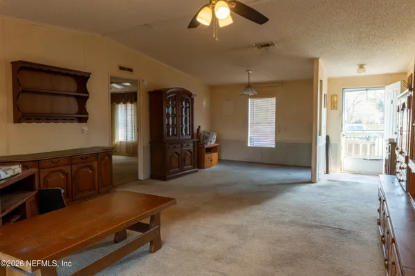 a living room with furniture pool table and flat screen tv