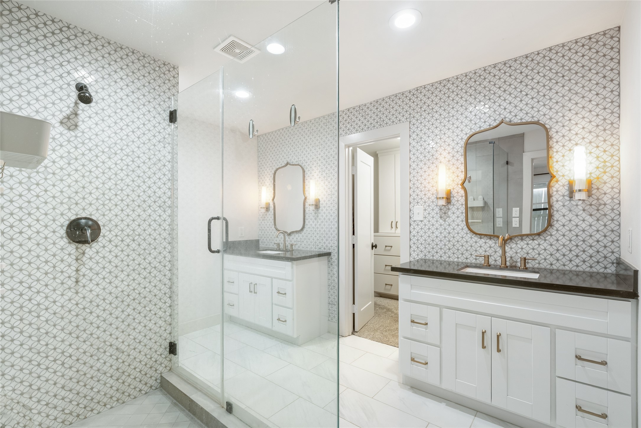 7307 Raton Street Houston, TX 77055 - Photo 5 of 23 Beautifully modern finishes are found throughout the home! This primary bathroom offers a unique tile design and frameless shower!