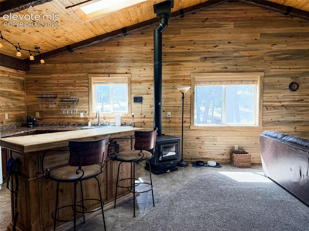 269 Southpark Road Florissant, CO 80816 - Photo 9 of 38 a view of a patio with table and chairs with wooden floor and fence