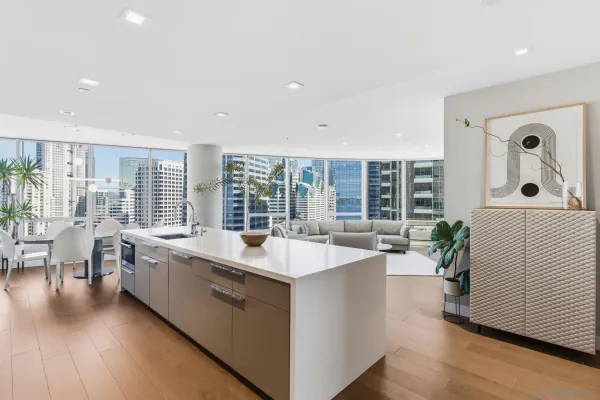 a large white kitchen with lots of counter space and glass door