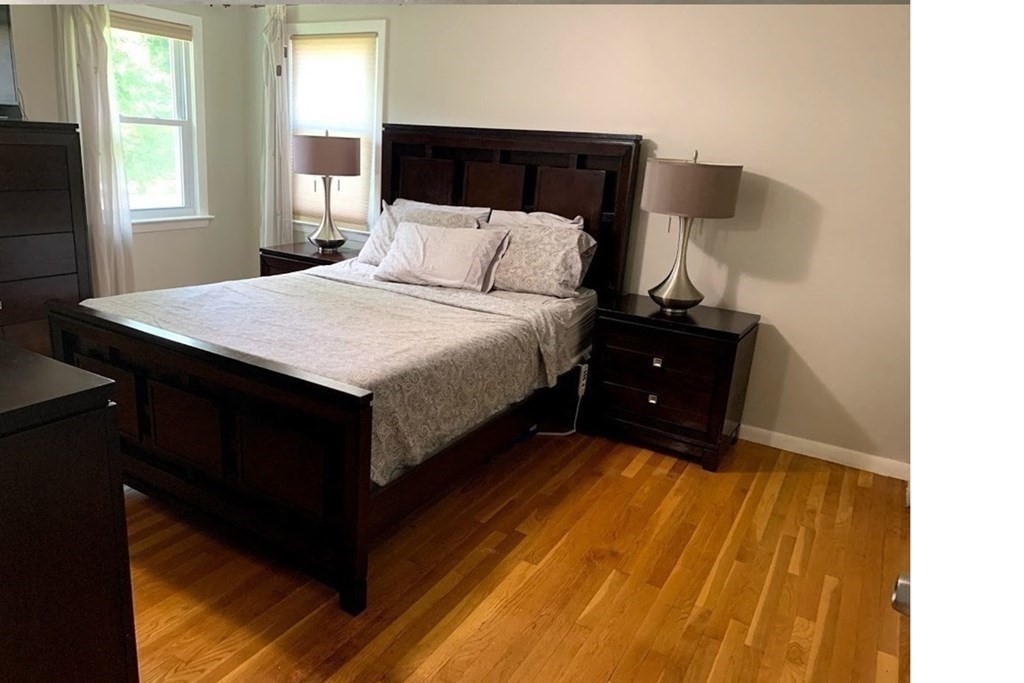 12 Burning Tree Road Natick, MA 01760 - Photo 12 of 34 a bedroom with a bed and a night stand