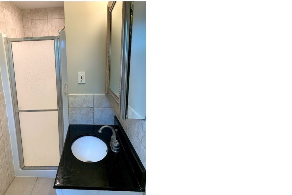 12 Burning Tree Road Natick, MA 01760 - Photo 14 of 34 a bathroom with a sink and a mirror