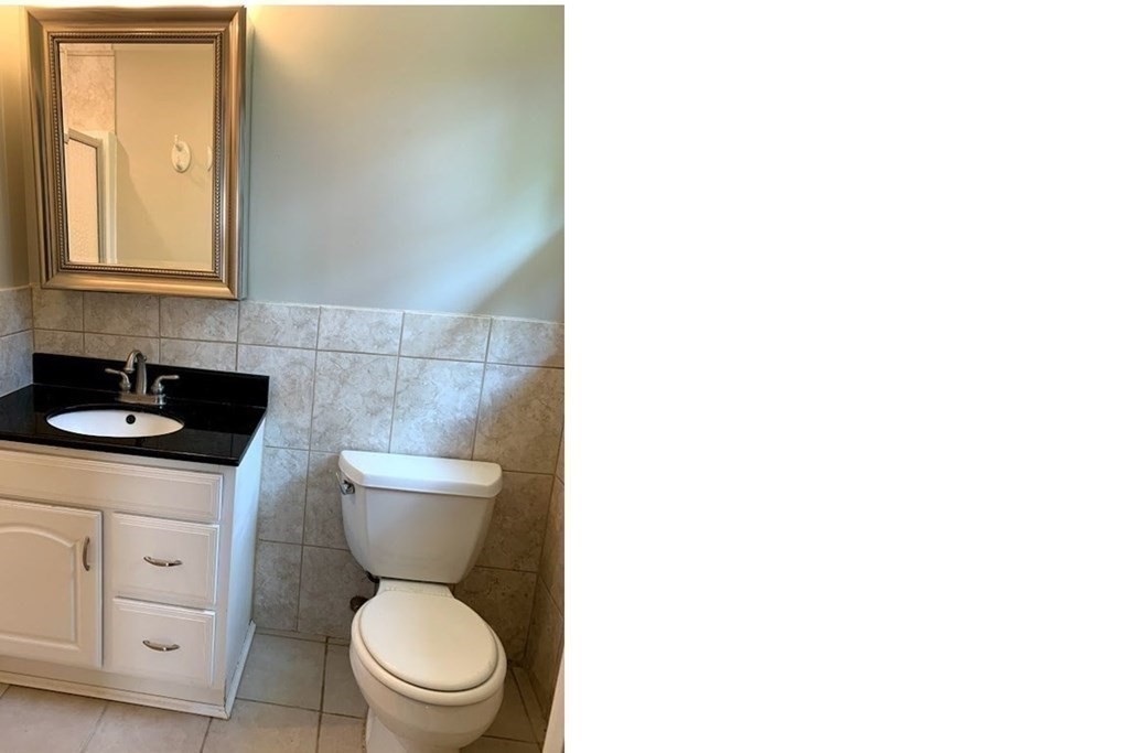 12 Burning Tree Road Natick, MA 01760 - Photo 15 of 34 a bathroom with a toilet a sink and mirror