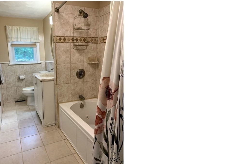 12 Burning Tree Road Natick, MA 01760 - Photo 19 of 34 a bathroom with a tub a toilet and a sink