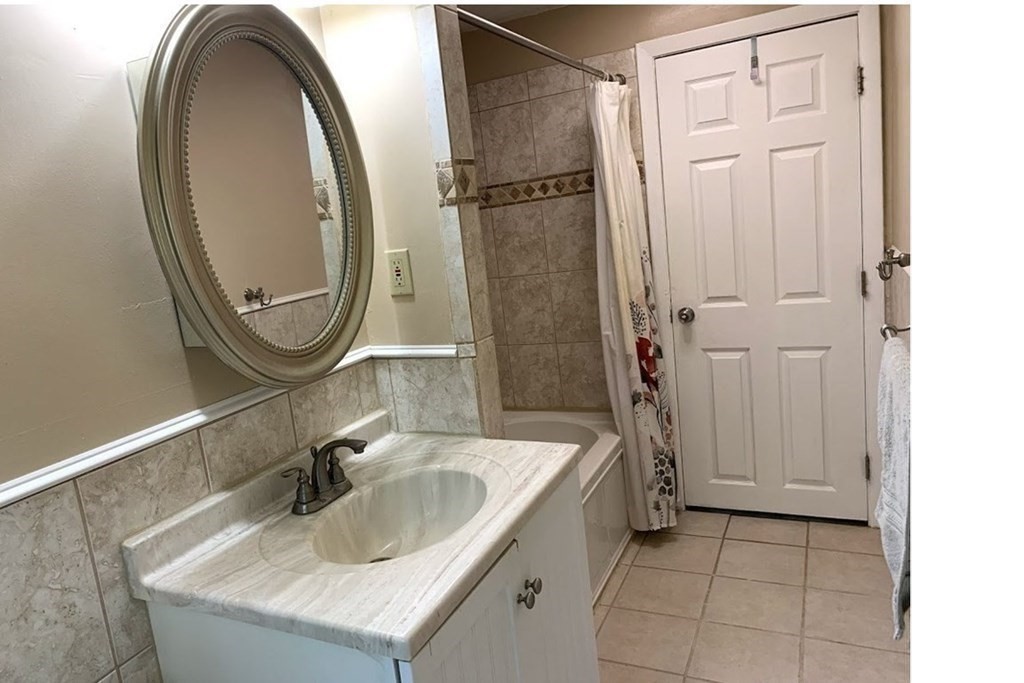 12 Burning Tree Road Natick, MA 01760 - Photo 20 of 34 a bathroom with a sink and a mirror