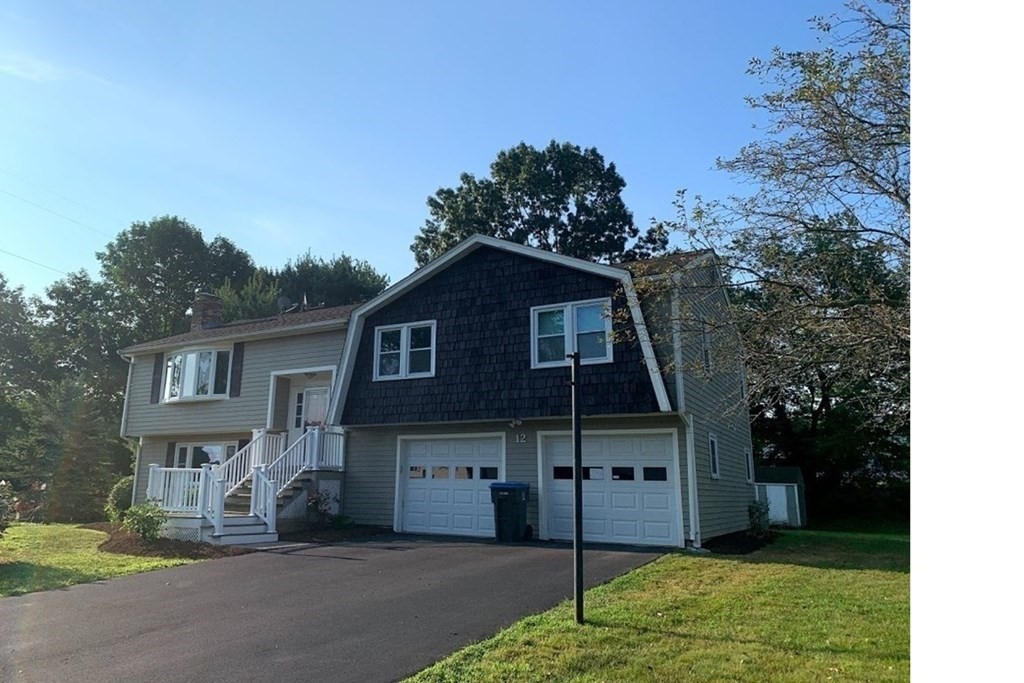 12 Burning Tree Road Natick, MA 01760 - Photo 2 of 34 a front view of a house with a yard