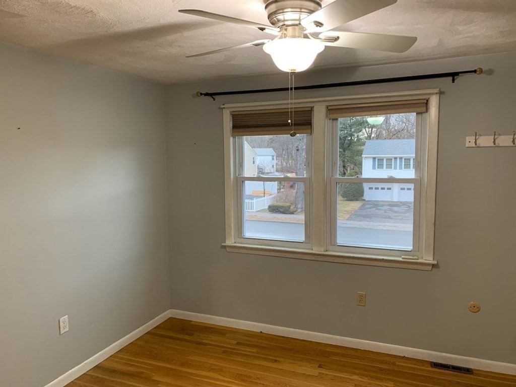 12 Burning Tree Road Natick, MA 01760 - Photo 21 of 34 a view of an empty room with wooden floor and a window