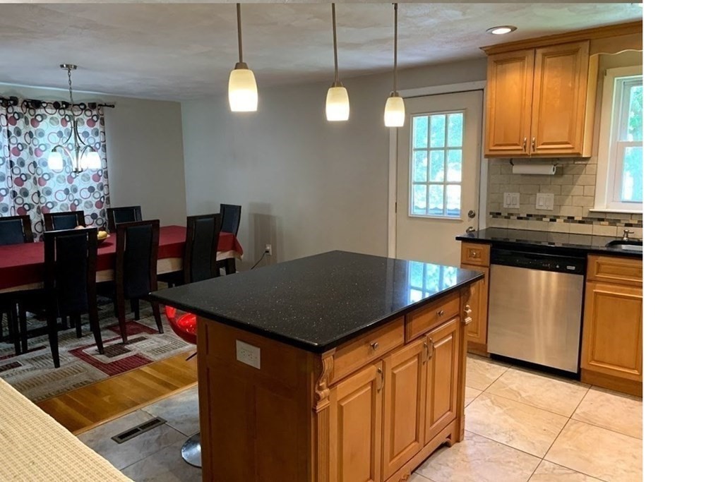 12 Burning Tree Road Natick, MA 01760 - Photo 5 of 34 a kitchen with stainless steel appliances granite countertop a sink a stove and a refrigerator