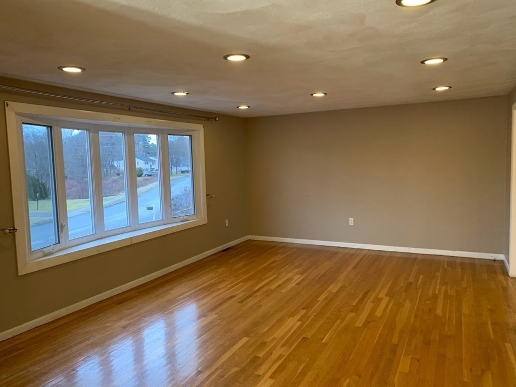 12 Burning Tree Road Natick, MA 01760 - Photo 7 of 34 a view of an empty room with wooden floor and a window