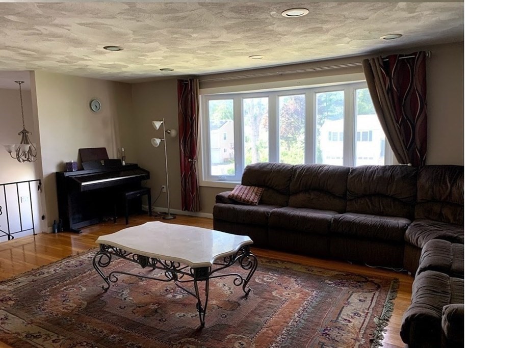 12 Burning Tree Road Natick, MA 01760 - Photo 8 of 34 a living room with furniture and a large window
