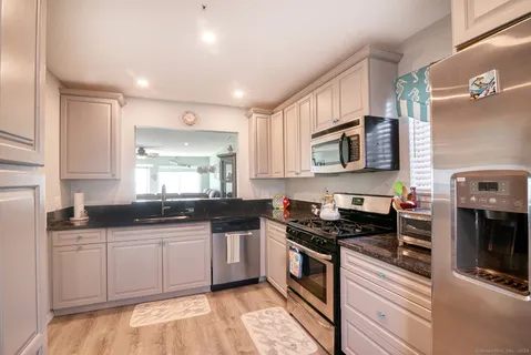 a kitchen with stainless steel appliances granite countertop a stove and a sink