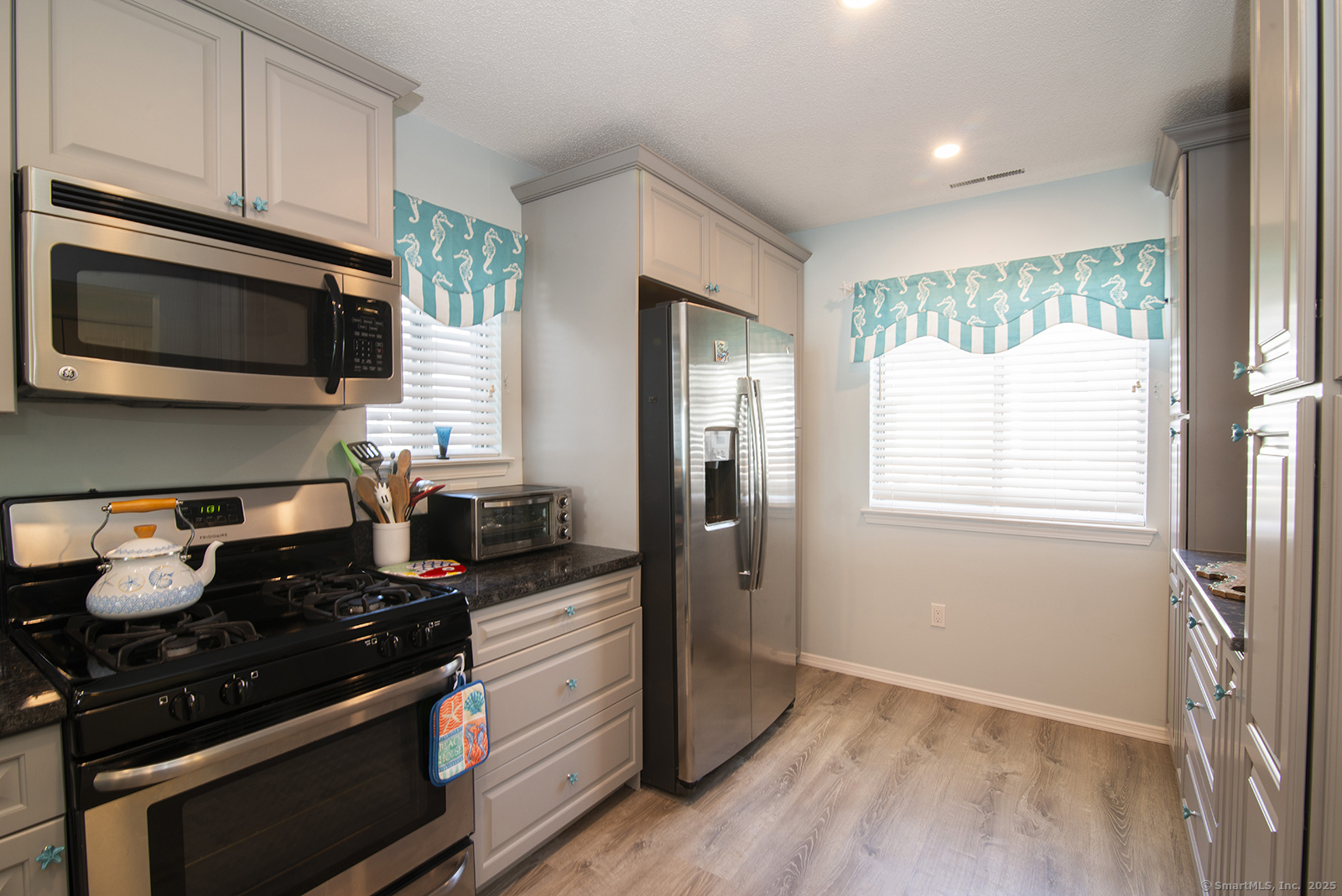 1 Mansfield Grove Road, Unit 306 East Haven, CT 06512 - Photo 14 of 31 a kitchen with a stove and a microwave