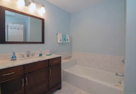 a bathroom with a toilet sink and mirror