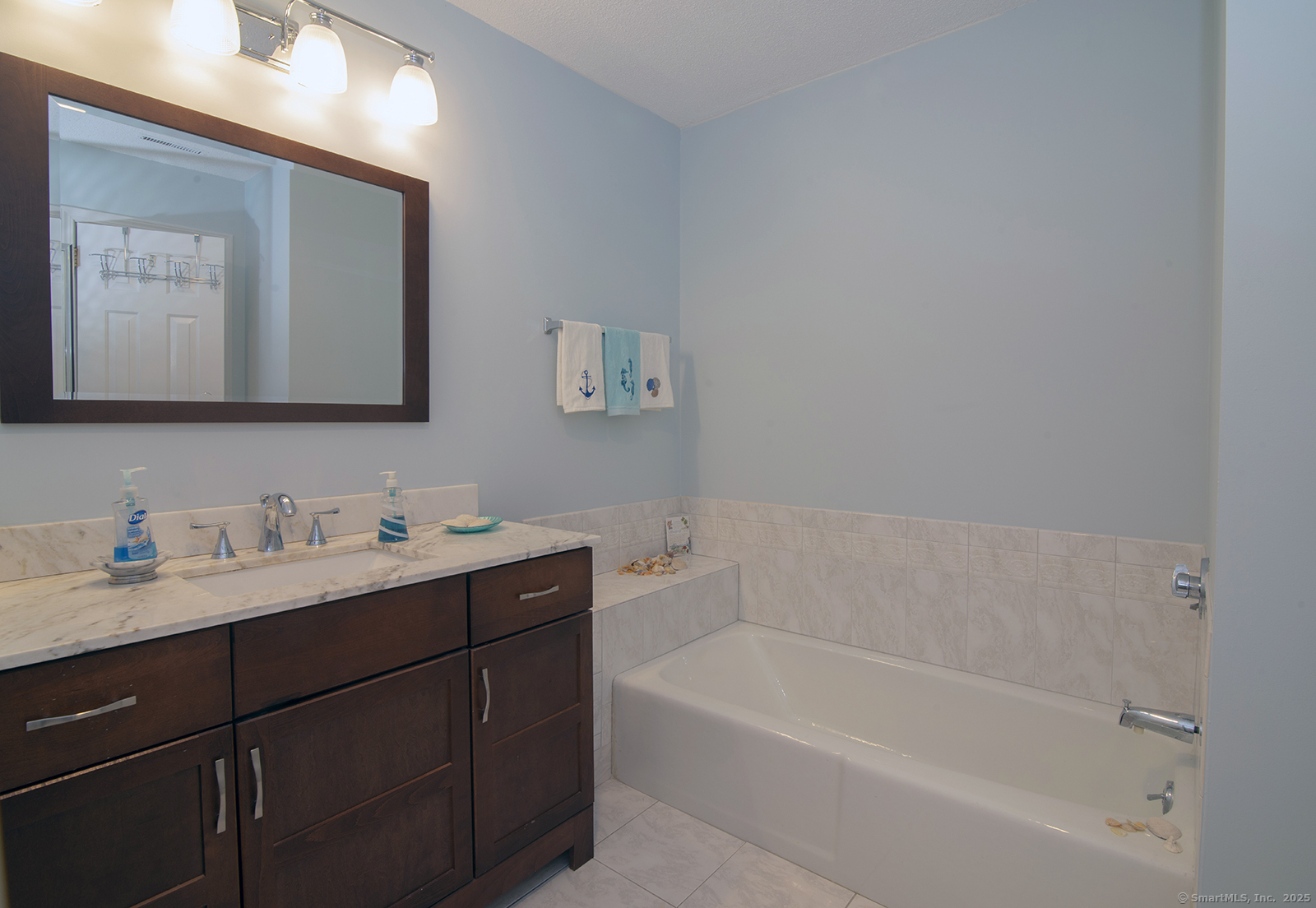 1 Mansfield Grove Road, Unit 306 East Haven, CT 06512 - Photo 17 of 31 a bathroom with a tub sink and mirror