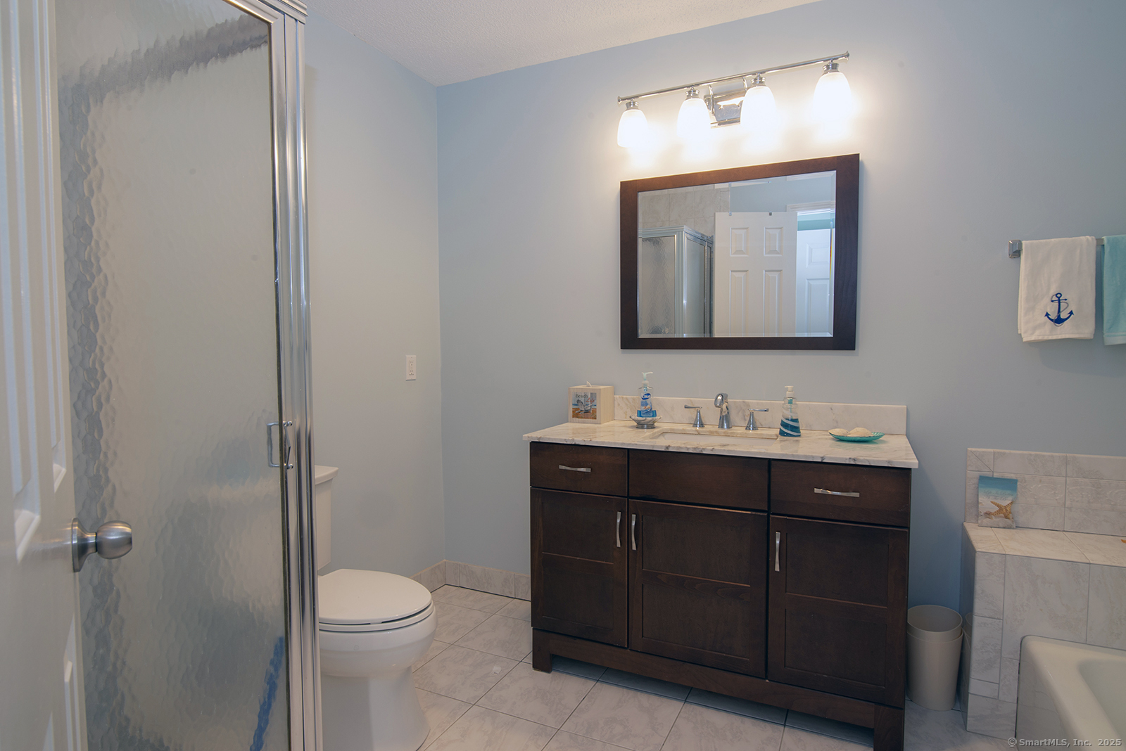 1 Mansfield Grove Road, Unit 306 East Haven, CT 06512 - Photo 18 of 31 a bathroom with a toilet sink and mirror