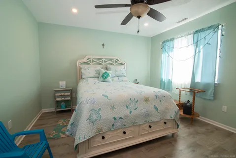 a bedroom with a bed and a chair