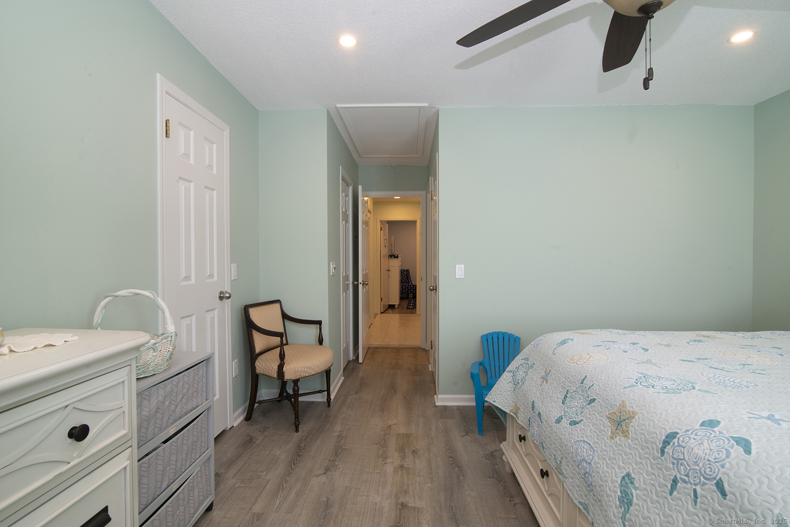 1 Mansfield Grove Road, Unit 306 East Haven, CT 06512 - Photo 21 of 31 a bedroom with a bed and a chair
