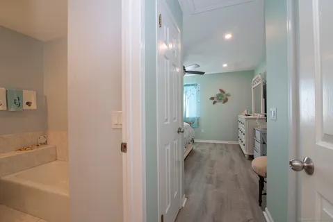 a bathroom with a granite countertop sink a toilet and a mirror