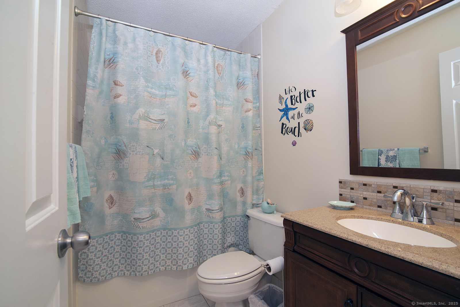1 Mansfield Grove Road, Unit 306 East Haven, CT 06512 - Photo 23 of 31 a bathroom with a granite countertop sink a toilet and a mirror