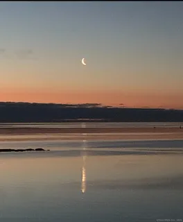 a view of an ocean beach and mountain