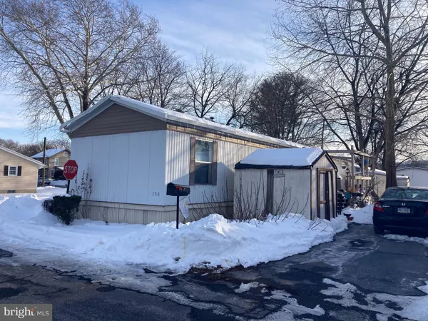 a view of a house with a yard covered in snow