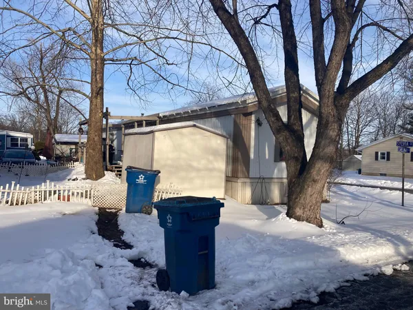 a view of a house with a tree and a yard