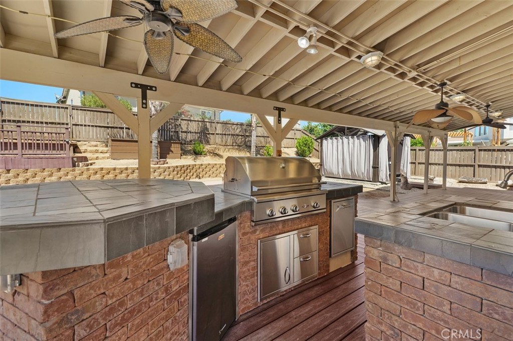 a kitchen with stainless steel appliances granite countertop a sink a stove and cabinets