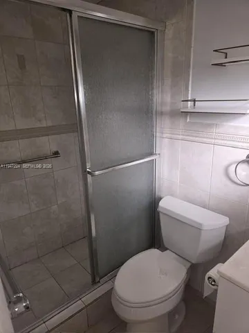 a white toilet sitting next to a bathroom sink