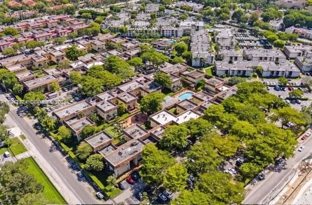 an aerial view of residential houses with outdoor space and street view