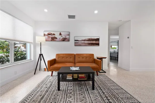 a living room with furniture and a rug