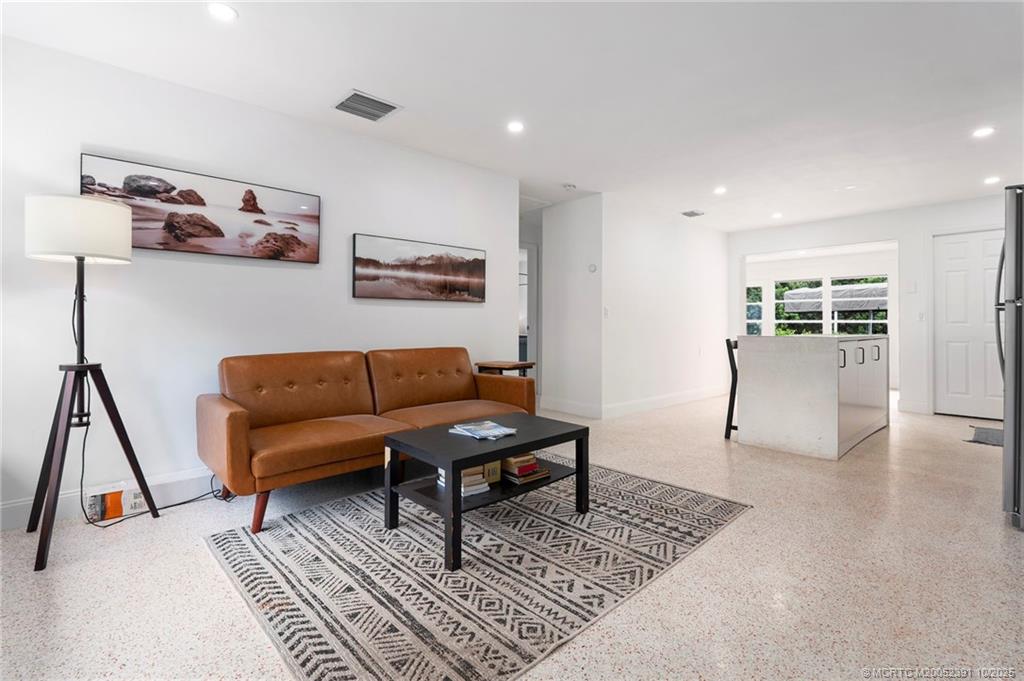 30 Southwest Hideaway Place Stuart, FL 34994 - Photo 12 of 45 a living room with furniture and a rug