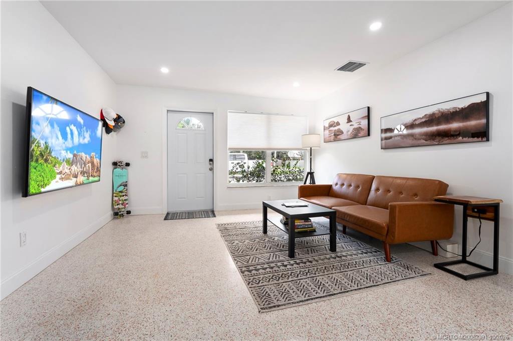 30 Southwest Hideaway Place Stuart, FL 34994 - Photo 13 of 45 a living room with furniture and a flat screen tv