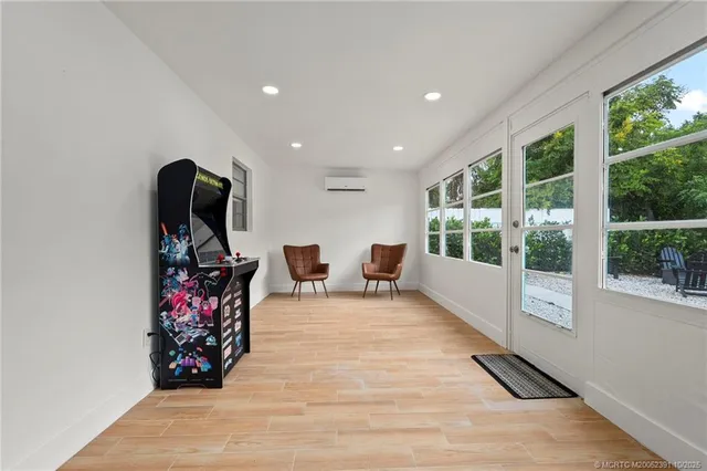 a view of a room with furniture wooden floor and windows