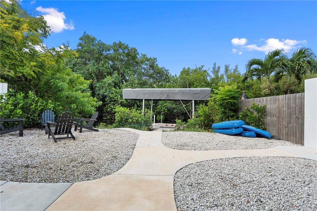 30 Southwest Hideaway Place Stuart, FL 34994 - Photo 38 of 45 a view of a backyard with a patio