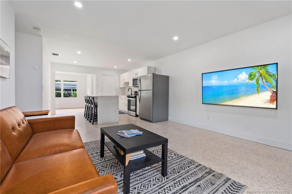 30 Southwest Hideaway Place Stuart, FL 34994 - Photo 9 of 45 a living room with furniture a refrigerator and a coffee table
