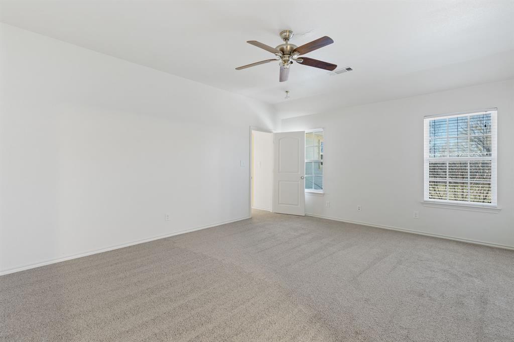 233 Firefly Drive Springtown, TX 76082 - Photo 10 of 16 Primary bedroom featuring a ceiling fan with natural light