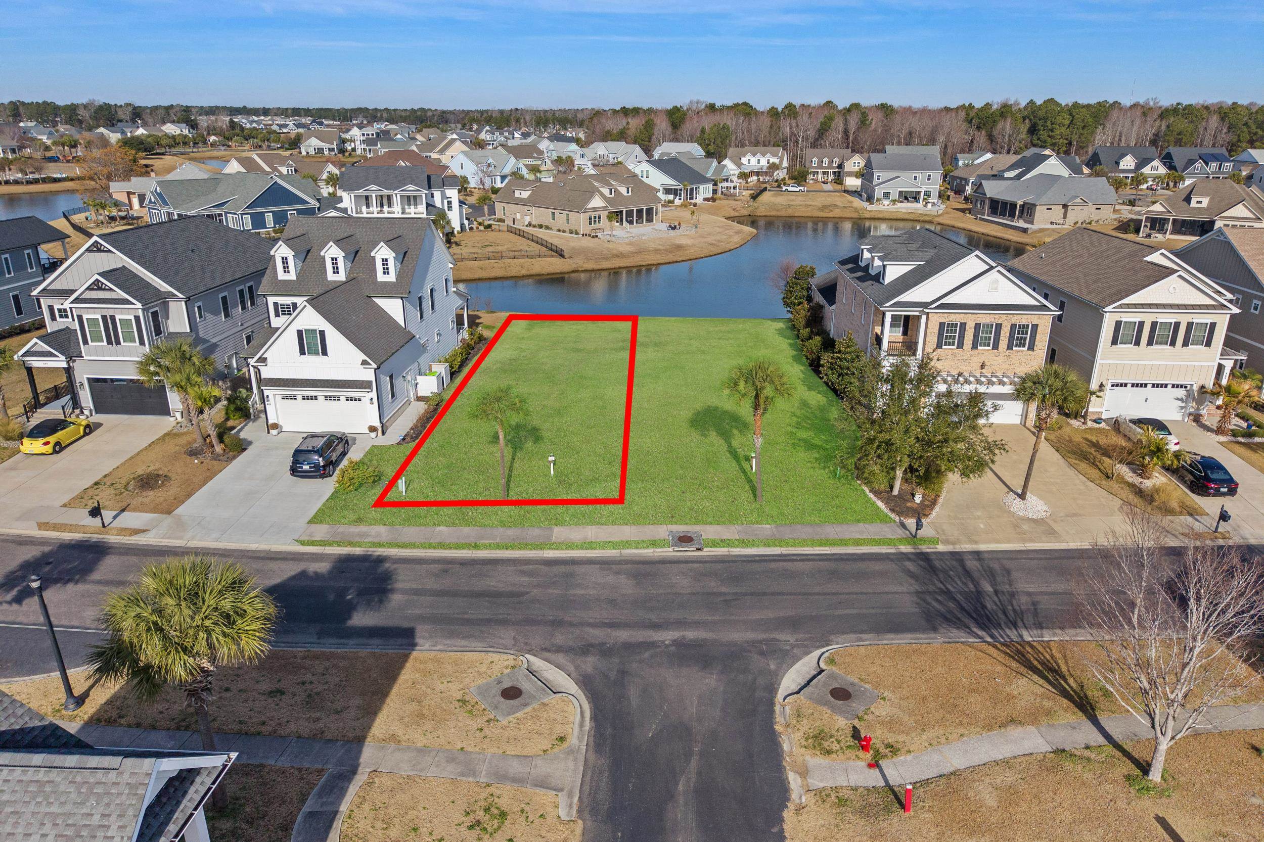 857 Crystal Water Way Myrtle Beach, SC 29579 - Photo 2 of 21 Aerial view of residential area with property boundaries highlighted and a nearby body of water