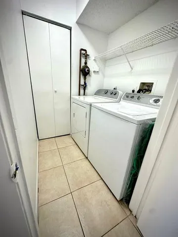 a utility room with cabinets washer and dryer
