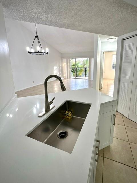9033 Wiles Road, Unit 304 Coral Springs, FL 33067 - Photo 4 of 12 a kitchen with a sink a counter top space and cabinets