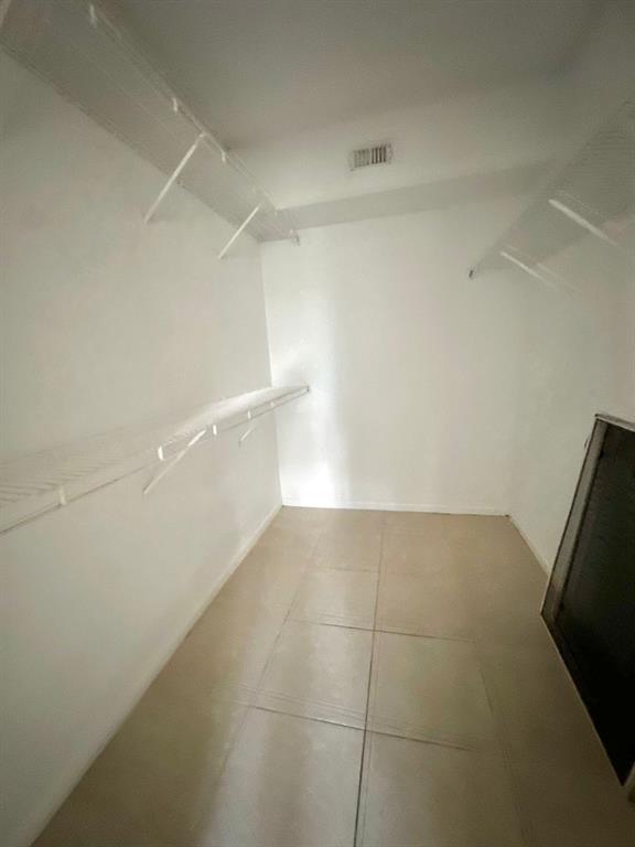 9033 Wiles Road, Unit 304 Coral Springs, FL 33067 - Photo 8 of 12 a view of an empty walk in closet