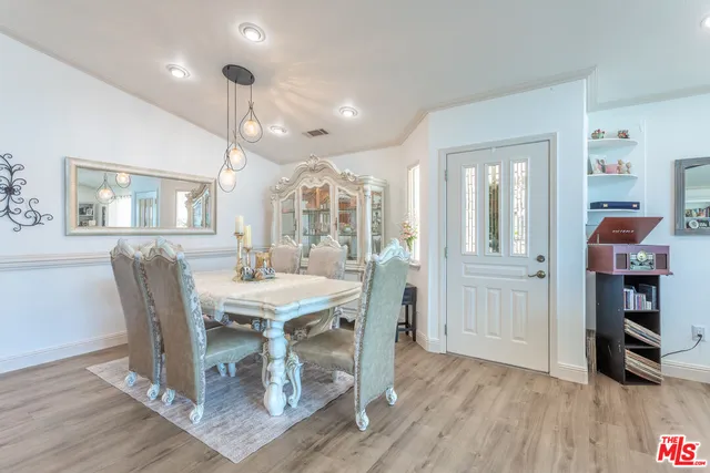 a dining room with furniture and wooden floor