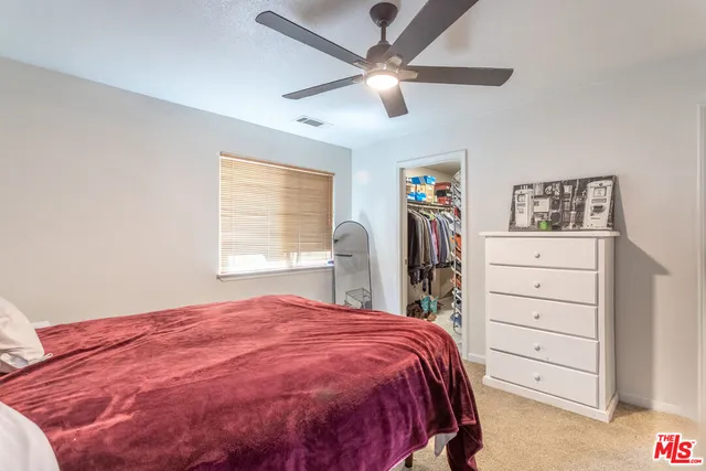 a spacious bedroom with a bed and a closet